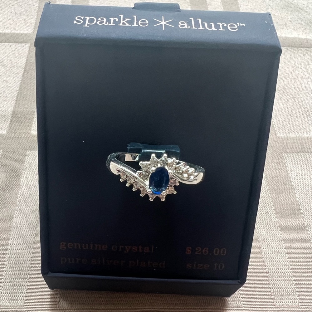 Silver plated ring with genuine crystals: one large blue and several small white